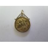 A George V gold full sovereign in a 9ct gold hallmarked pendant mount, total weight approx 9.8 grams