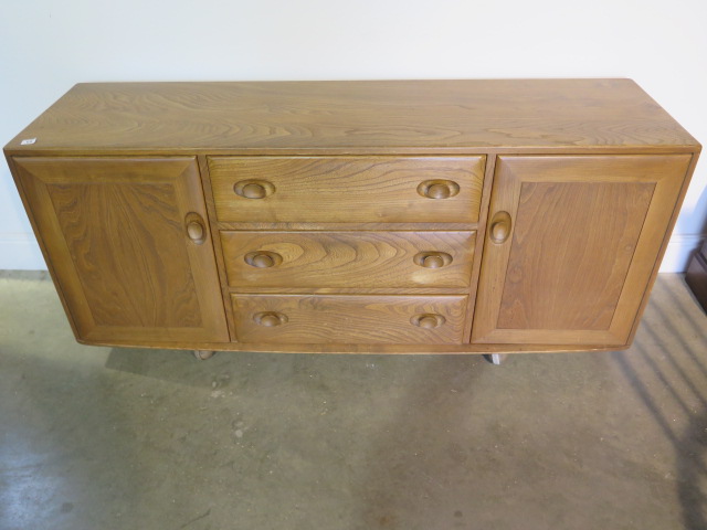 An Ercol blond elm sideboard with 3 drawers and 2 cupboard doors, 67cm tall, 156cm x 43cm, in good