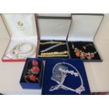 An assortment of costume jewellery and watches