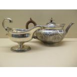 A Victorian silver teapot, hallmarked London 1880-81, marked FE, 13.5cm high, and a silver sauce