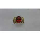 A 14ct Mandarin Garnet and diamond ring, the garnet approx 11mm x 8.5mm x 5.5mm, ring size O, approx