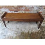 A mahogany window seat on turned legs, 52cm tall, 129cm x 36cm, in sturdy condition
