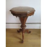 A Victorian walnut trumpet work table with mother of pearl inlay with assorted sewing related