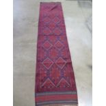 A hand knotted woollen Meshwani runner, 262 cm x 63cm