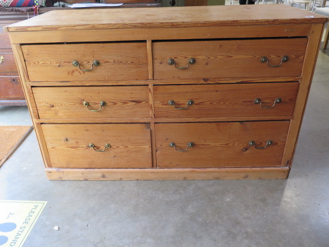 A stripped pine bank of 6 drawers, 83cm tall x 137cm x 55cm