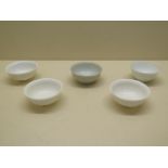 Three 19th century porcelain small bowls each with a pair of dragons chasing a pearl together with