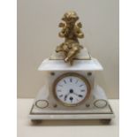 An alabaster mantle clock with cherub on top, 8 day French movement, 29cm tall, not currently