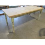 A pine kitchen table with a stripped top on painted turned legs, 76cm tall x 186cm x 76cm