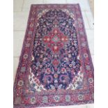 A hand knotted woollen Hamadan rug, 2.30m x 1.25m