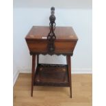 A pretty Edwardian rosewood inlaid basket workbox with a carry handle and 2 door lift uptop above