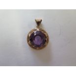 A synthetic colour change sapphire in a gold pendant mount, tests to approx 15ct, 20mm wide,