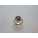 A 14ct yellow gold sapphire and diamond ring - the sapphire measures approx 9mm x 7mm x 4mm -