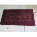 A hand knotted woollen rug, 155cm x 85cm
