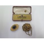 A pair of gilt metal brooches, approx 19 grams, a pin marked 15ct, approx 1 gram and a gold and