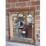 A gilt cushion mirror, 63cm x 53cm