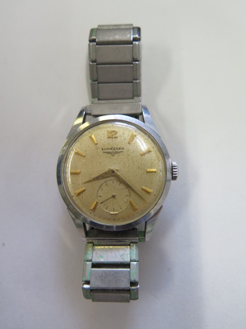 A Longines manual wind gents wristwatch, case 34mm wide, running in saleroom, some wear and spotting