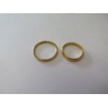 Two 22ct hallmarked yellow gold band rings, sizes V and O, total weight approx 8.8grams