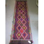 A hand knotted woolen runner 252 x 75cm in good condition