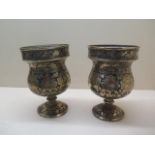 A pair of enamelled brass goblet shape vases, 19cm tall, generally good condition with some usage