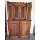 A late 20th century stained pine cabinet with breakfront top containing an arrangement of drawers