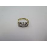 A hallmarked 18ct yellow gold three stone diamond illusion set ring, size K, approx 3.4grams,