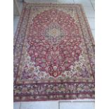 A hand knotted woollen Kashan rug, 3.03m x 2.0m
