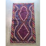 A hand knotted woollen Baluchi rug, 143cm x 80cm