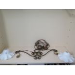 A brass rise and fall twin branch hanging lamp with white glass shades