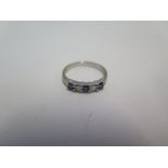 An 18ct white gold 3 stone sapphire and 2 stone diamond band ring, ring size K/L, approx 2.6grams,