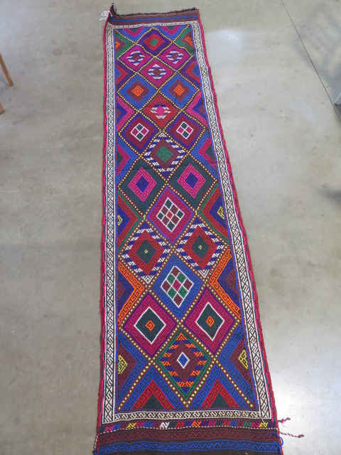 A hand knotted woollen Suzni Kilim runner, 263cm x 65cm