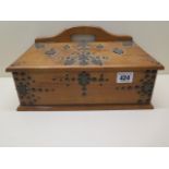 An early 20th century Continental wooden desk top box with applied metal work decoration and
