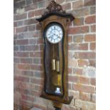 A good quality 19th century walnut double weight Vienna wall clock in a shaped case, in good