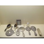 A collection of five silver back dressing table hand mirrors, a silver back brush, 2 silver and