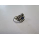 A 14ct white gold sapphire and diamond ring, the central dark blue sapphire, approx 4mm x 3mm