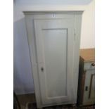 A painted pine cupboard with hinged door and four internal shelves, 137cm tall x 63cm wide x 37cm