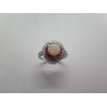 A platinum opal, ruby and diamond ring, hallmarked, size M, head approx 12mm, approx 5 grams, in