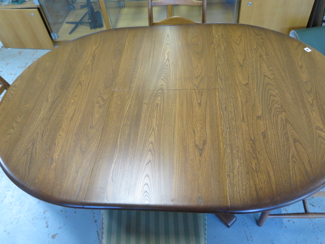 An Ercol elm oval extending dining table and 4 chairs with seat pads, 74cm tall x 166cm x 114cm - Image 2 of 7