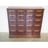 A mahogany chemist apothacary chest with 20 named graduating drawers incorporating 19th century