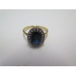 An 18ct yellow gold diamond and dark blue sapphire ring, size R, approx 4.6grams, marked 18ct.