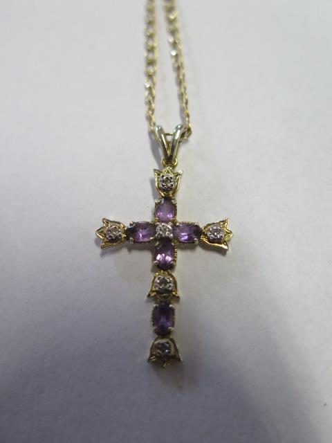 A 9ct gold crucifix pendant and chain inset with diamond and amethyst, overall weight approx 3.8