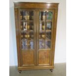 A French 19th century rosewood inlaid bookcase, the glazed doors opening to reveal five internal