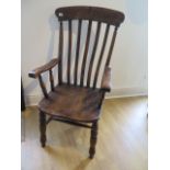 A 19th century ash and elm elbow chair, some movement to joints and old worm but a good colour