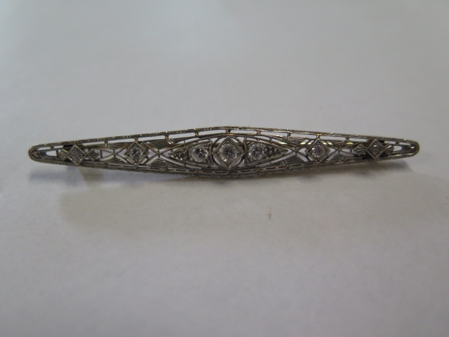 A continental yellow gold and diamond set brooch with white metal setting, 7cm long and the