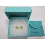 A pair of Tiffany 18ct gold earrings, stamped 'T & Co 750', approx weight 5.8 grams, with suede