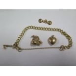 A 9ct gold bracelet, approx 18cm long with a 15ct charm and two other charms, total approx 11.6