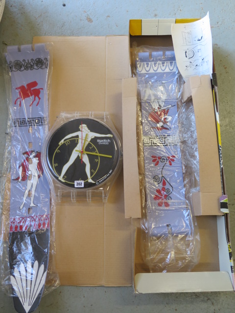 A Maxi Swatch wallclock 1991 in original box, box is 100cm long, clock in original packing, some