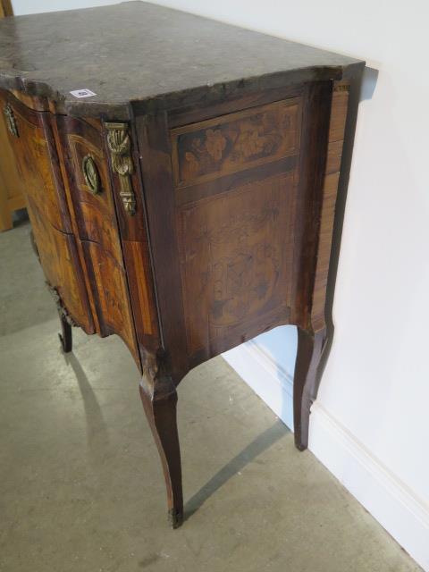 A French 19th century two drawer chest with marble top over a shaped marquetry inlaid base comprised - Image 4 of 10