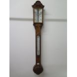A late 19th century oak cased stick barometer with foliate carved embellishments, ivory plate and
