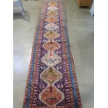 A hand knotted woollen Karajeh rug, 3.70m x 0.85m, in good condition