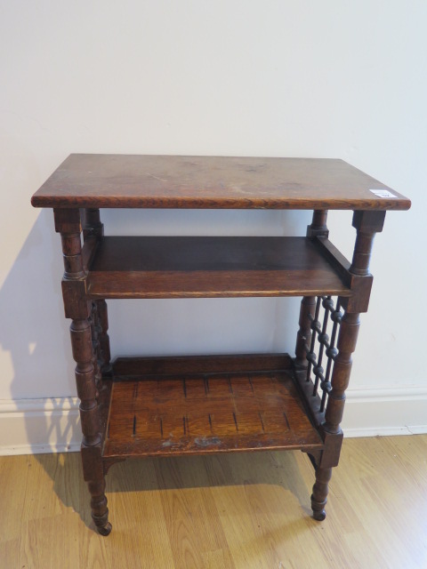 An oak three tier side table, probably Liberty & Co, with lattice work sides on short turned legs,